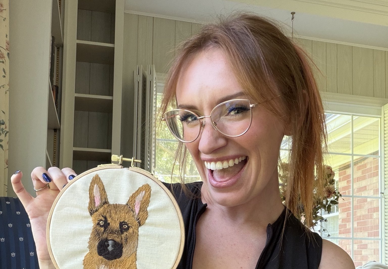 Maddy holding her German shepherd embroidery hoop